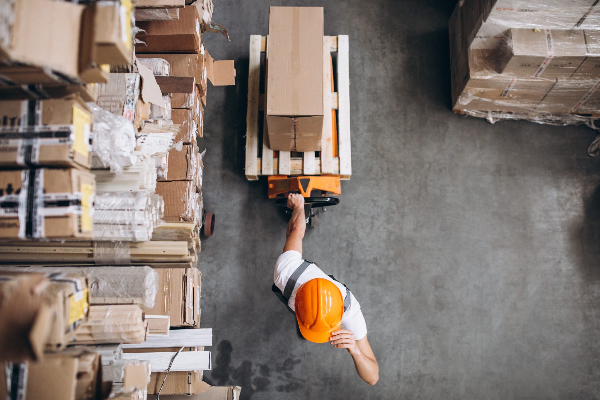 young man working warehouse with boxes scaled